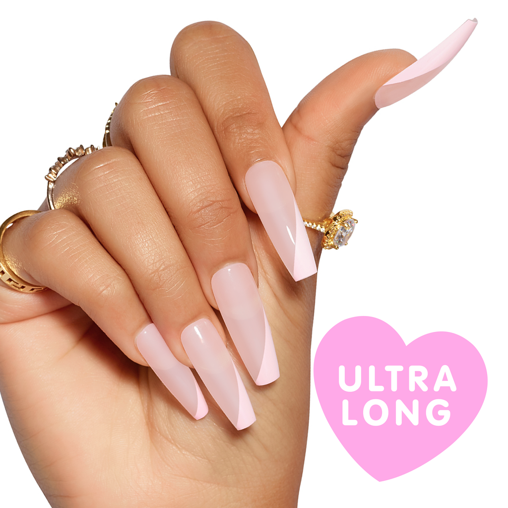 Hand wearing baby pink jelly nails with side tip in pink, extra long coffin press on nails