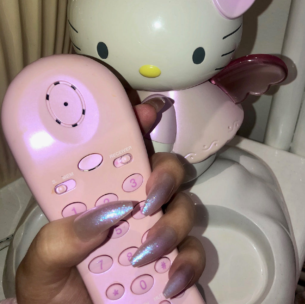 Influencer wearing long ballerina press on nails in nude and iridescent shimmer