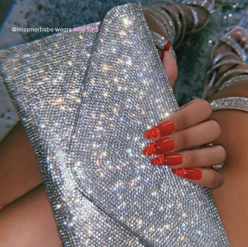 Influencer wears classic red jelly stick on nails in long tapered ballerina
