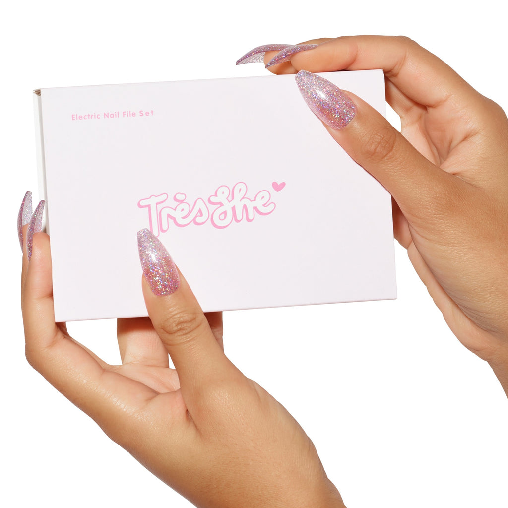 Hands holding packaging of min electric nail file tool by Tres She