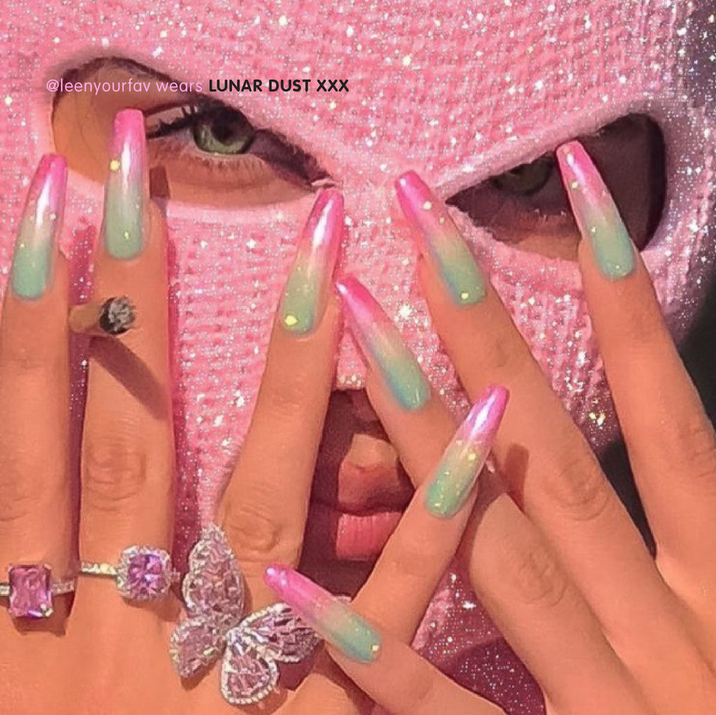 Influencer wearing ultra long coffin press on nails in ombre pink yellow green glitter