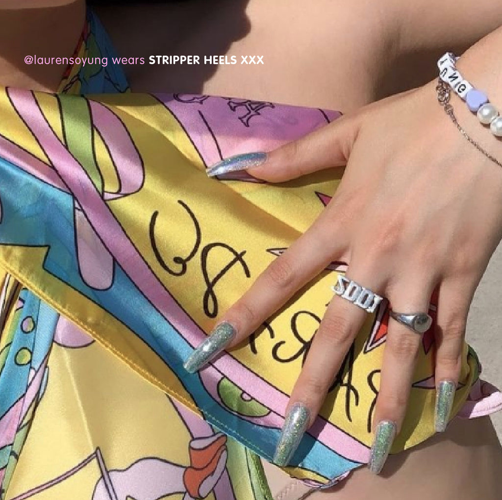 Influencer wearing ultra long coffin press on nails in Stripper Heels holographic and iridescent glitter