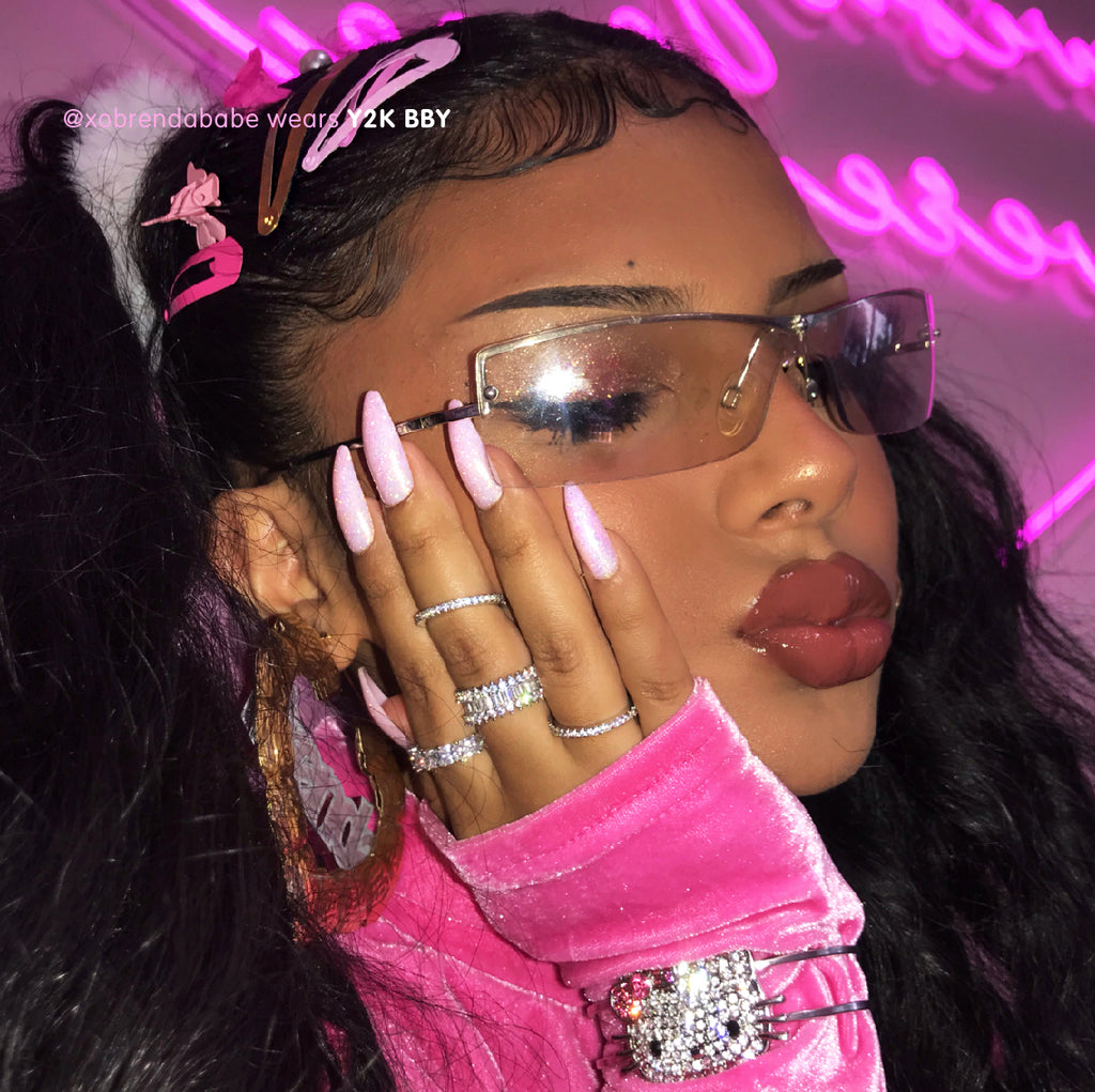 Influencer wearing baby pink sparkle press on instant acrylic nails in long tapered ballerina
