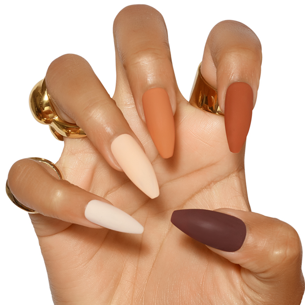 Hand posed in claw wearing press on nails in five different nude shades from dark to lighter