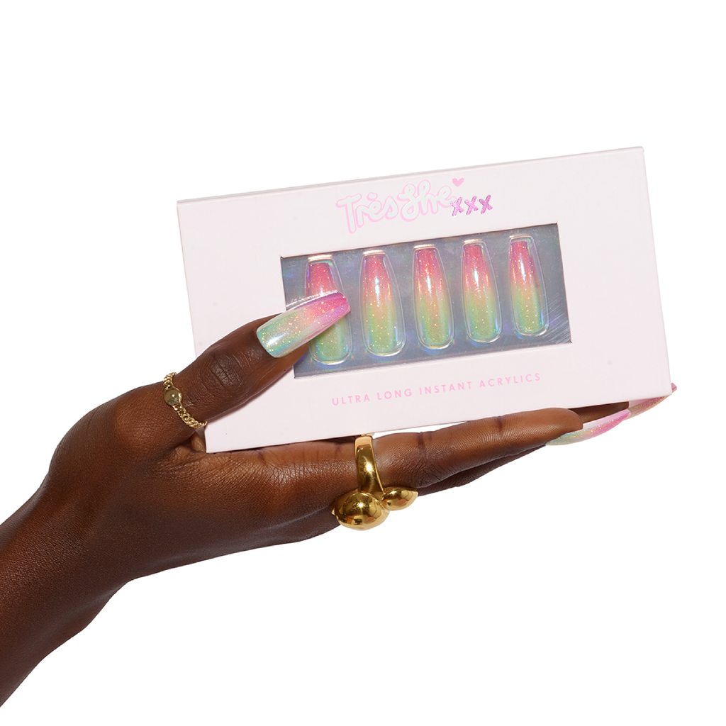 Hand holding box of pastel extra long press on nails while wearing same nails