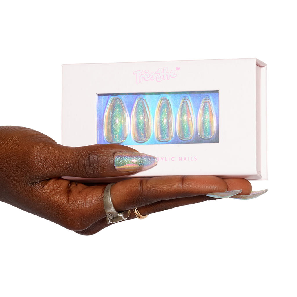 Hand holding box of long tapered ballerina stick on instant acrylic nails in holographic and iridescent glitter wearing the same nails