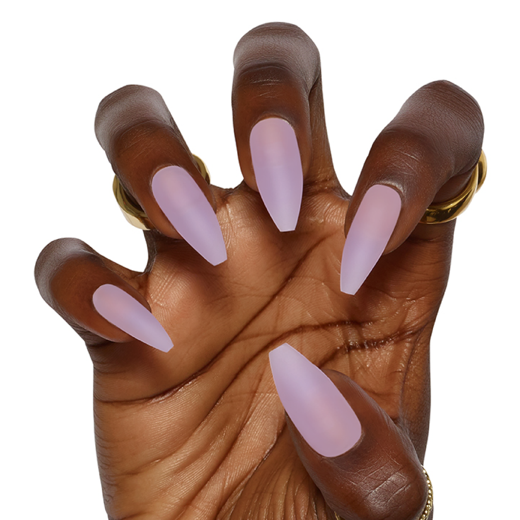Hand posed in claw wearing matte lilac jelly press on acrylic nails