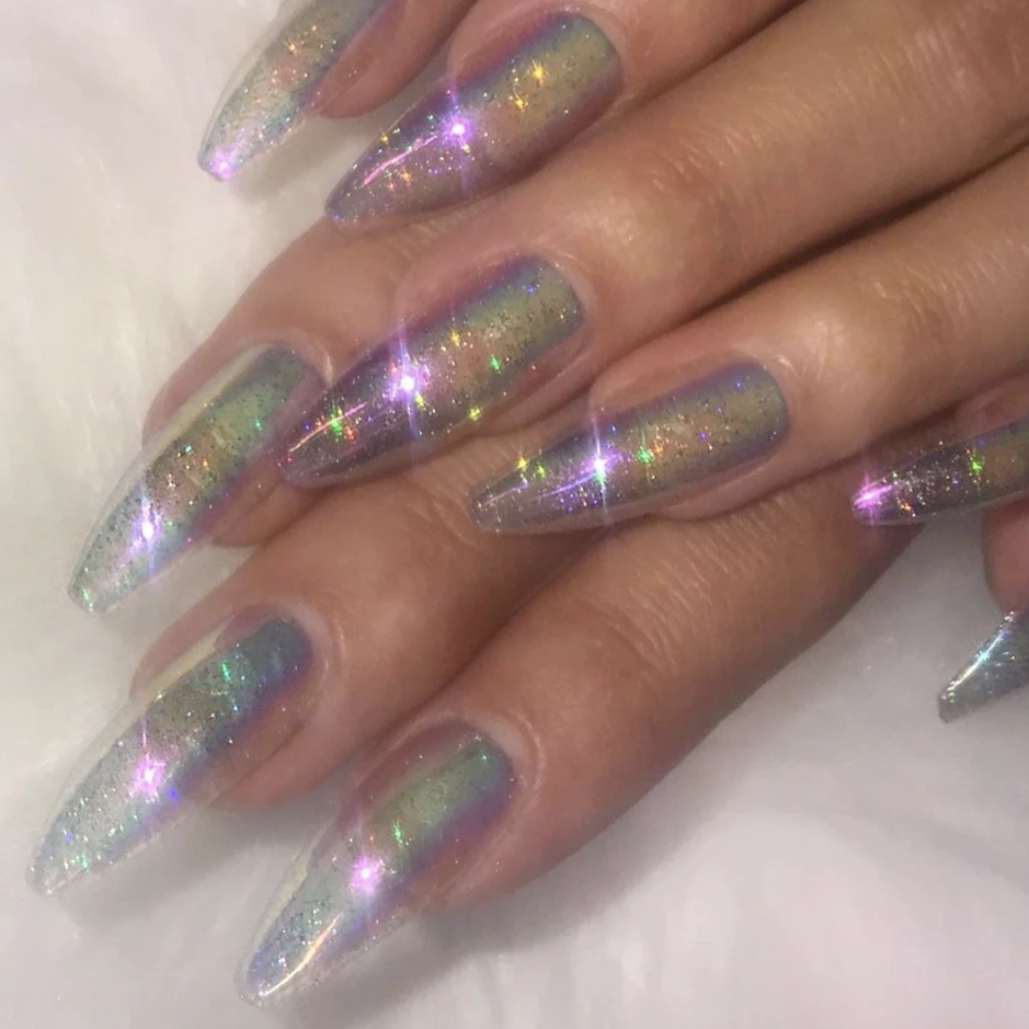 Hands wearing long ballerina holographic glitter and iridescent press on instant acrylic nails